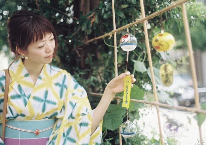 風鈴を見る浴衣の女性